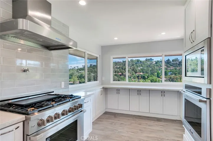 Dacor range, oven and microwave, stainless hood, newer cabinetry, quartz counter and breakfast nook.  Note the gorgeous view!