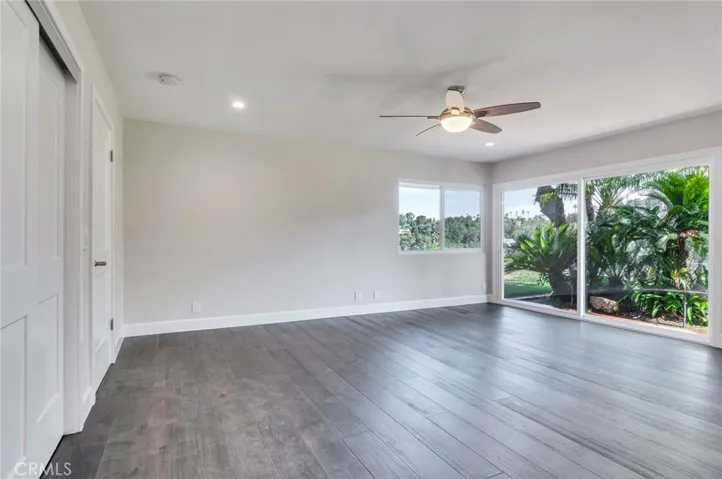 Reverse angle of primary bedroom, walk in closet, newer dual pane window and door