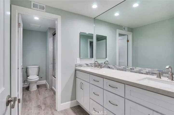 Remodeled hallway bathroom with dual sinks