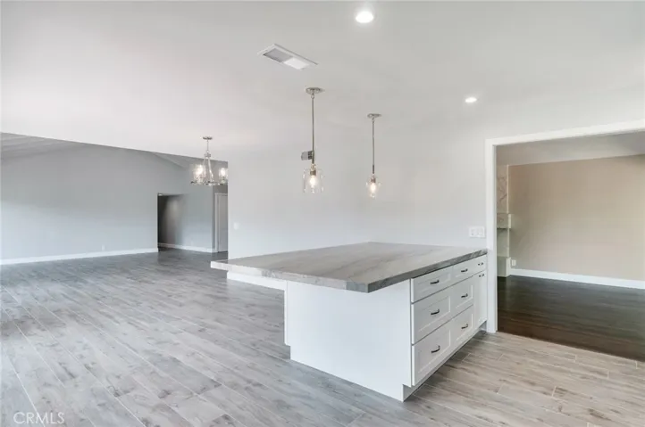 Center island has quartzite counter with breakfast bar and lots of seating