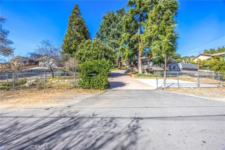 Street level entrance with driveway on an uphill slope and rolling gates for access.