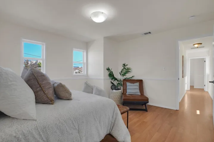 Bedroom with light wood-style flooring and baseboards