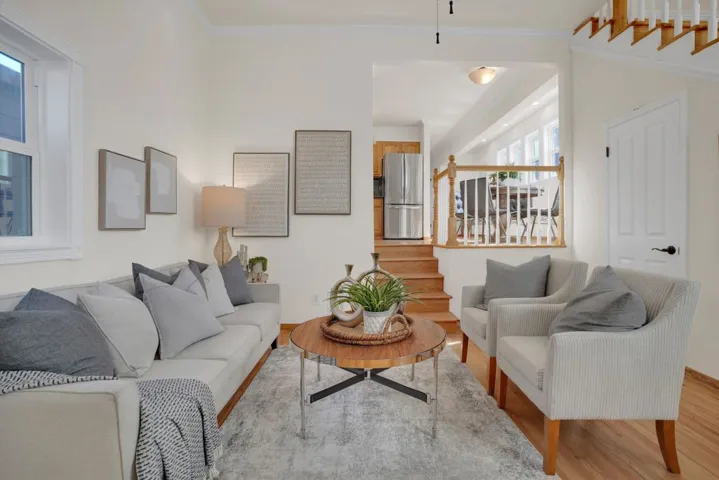 Living area featuring stairway and wood finished floors