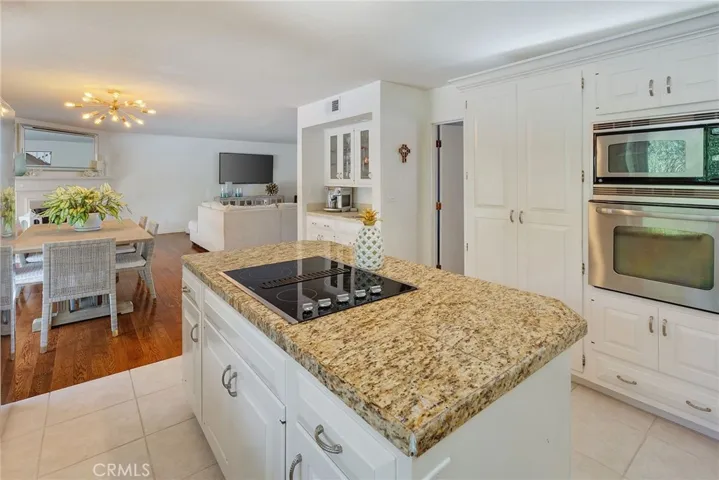 Next to the Dining Area is a Wt Bar/Coffee Bar For Entertaining. The Dining Area also leads to two Outside Balconies for BBQ and access down to a Patio.