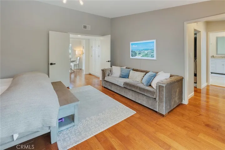 Another View of the primary Suite Showing connection to a hallway and closets on both sides.