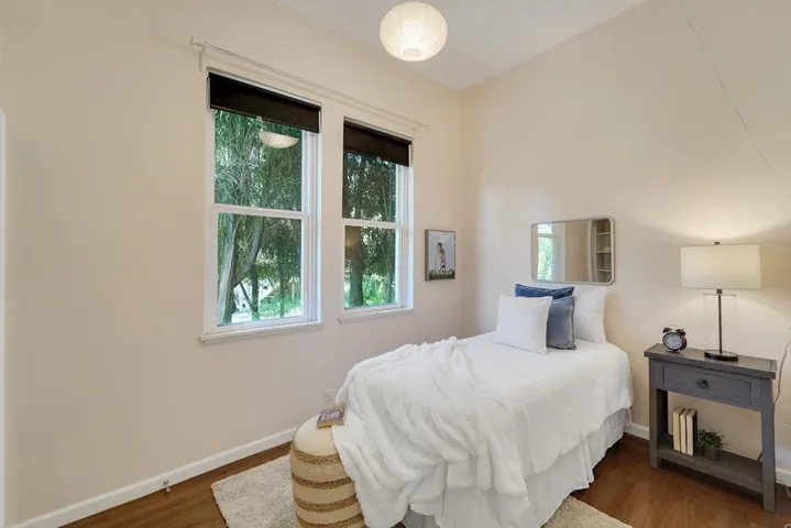 Bedroom with dark wood-style flooring