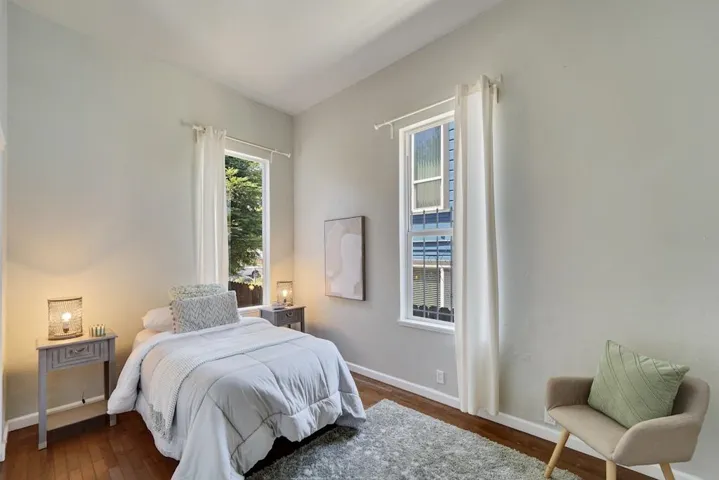 Bedroom with dark wood-style floors
