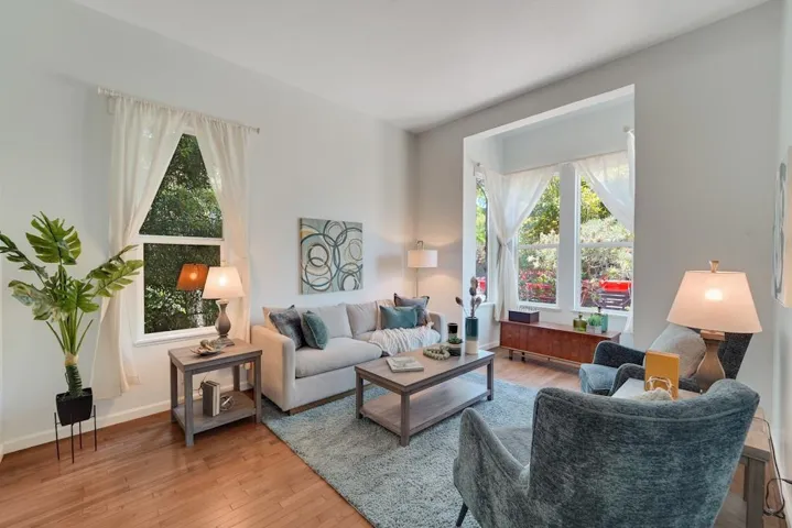 Living room featuring light wood-type flooring and plenty of natural light