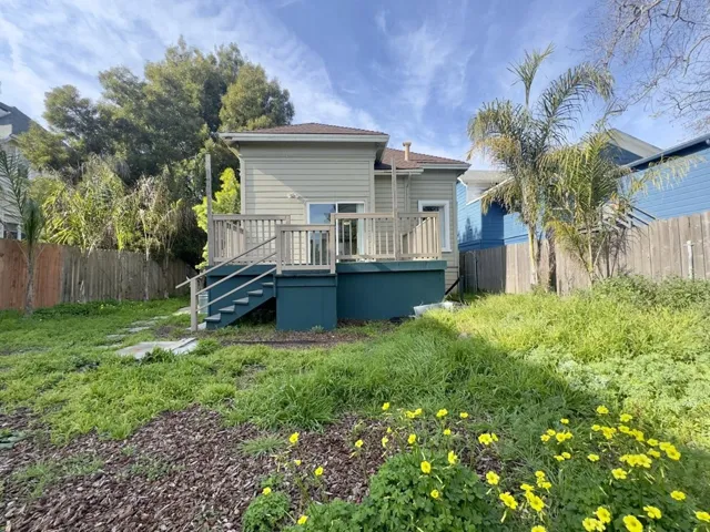 Back of house featuring a wooden deck and stairway