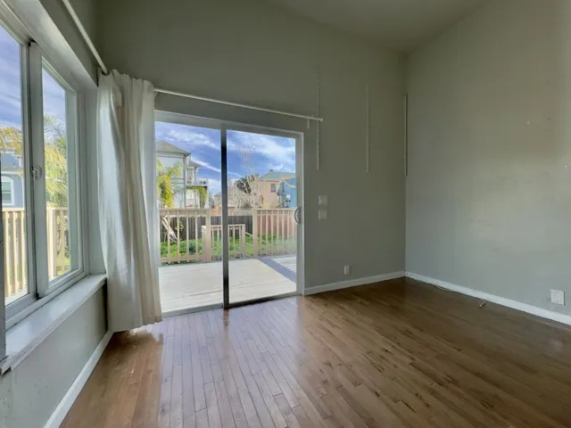 Spare room with baseboards and hardwood / wood-style floors