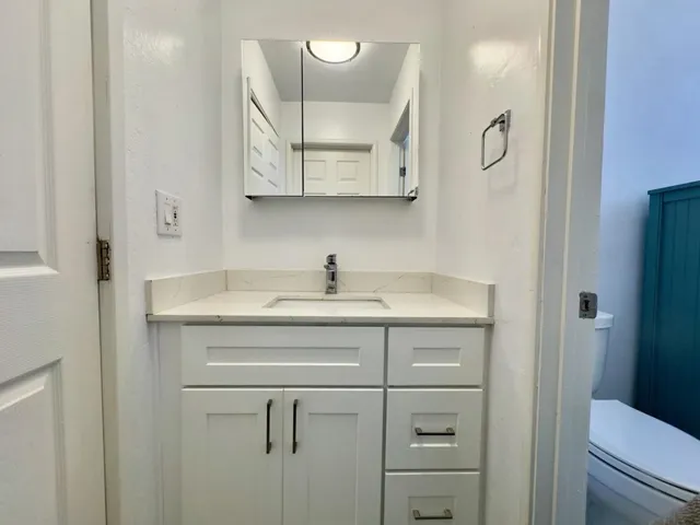 Half bath featuring vanity and toilet