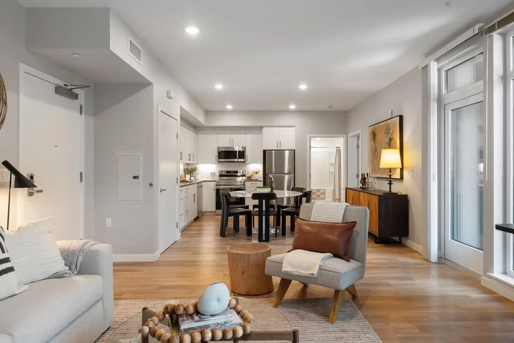 Living area featuring recessed lighting, light wood-style floors, and electric panel