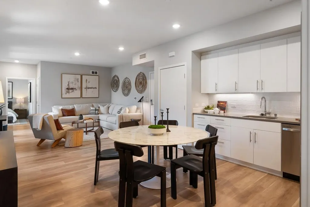 Dining room with light wood finished floors and recessed lighting
