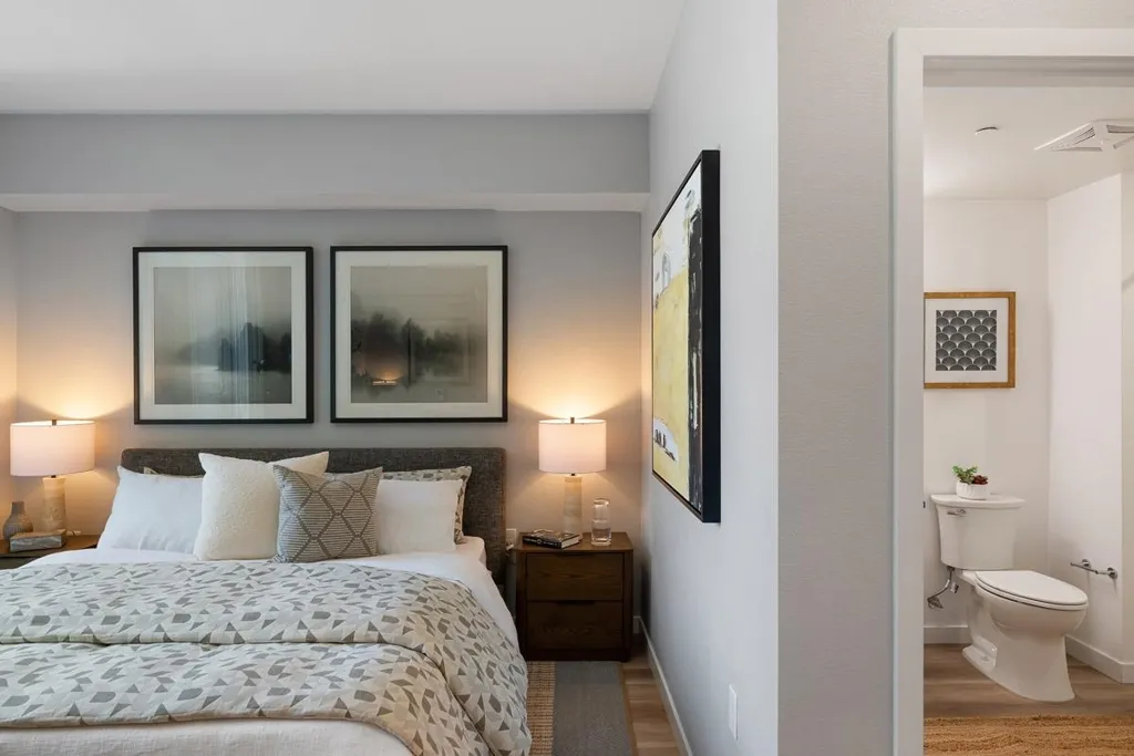 Bedroom featuring wood finished floors and ensuite bath