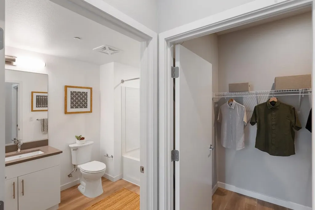 Full bathroom featuring light wood finished floors, vanity, and  shower combination