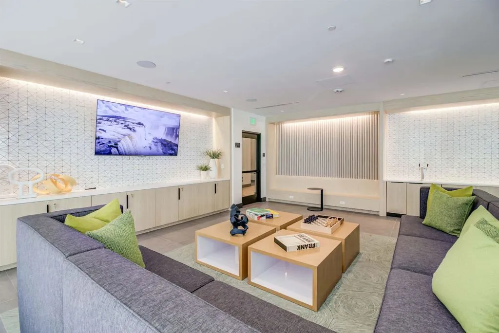 Living area with wallpapered walls, light tile patterned floors, and recessed lighting