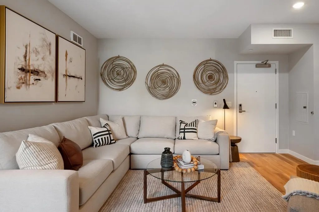 Living room with wood finished floors and electric panel