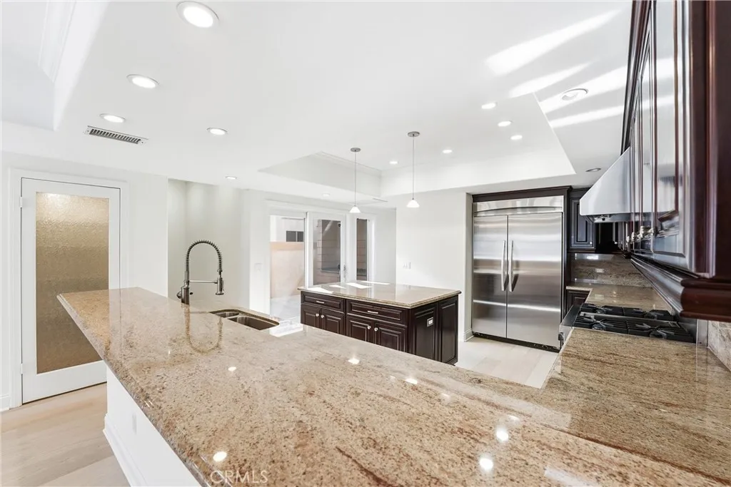 Across the counter and sland the pantry, private outdoor patio is seen