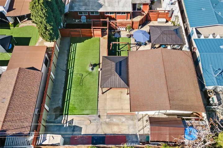 Aerial of outdoor "play" area, garage, entertainment area and shed.