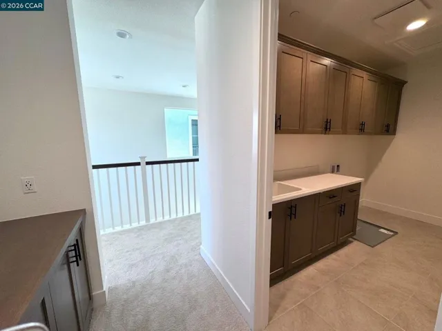 Laundry room with upper cabinets