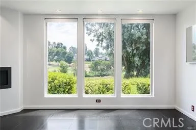 Large windows frame serene, tree-lined views and flood the space with natural light.