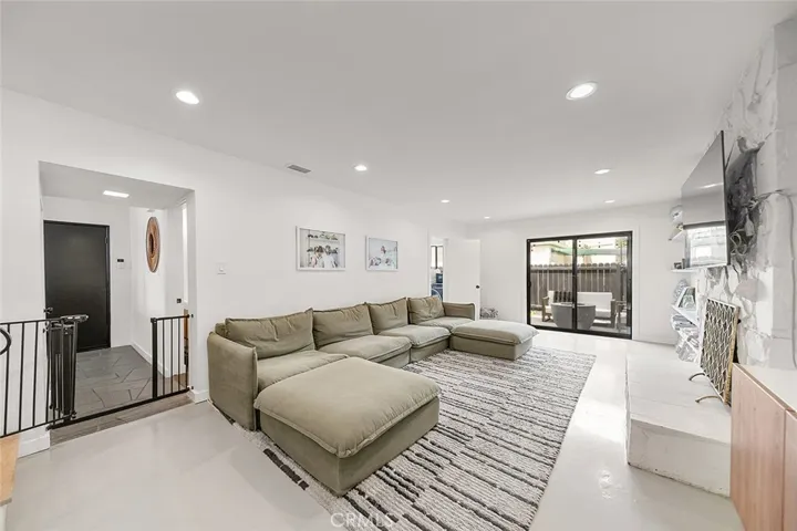 Downstairs Lounge-Like Living Area with Fireplace - and Access to Side Patio