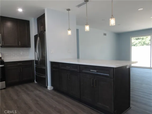 Peninsula counter with quartz counter and remodeled cabinets