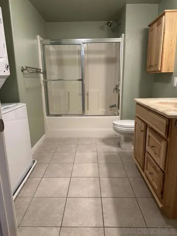 Second bathroom with stackable full size washer dryer