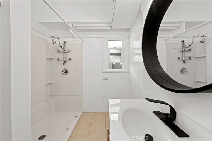 Hallway bathroom has a full sized walk in shower