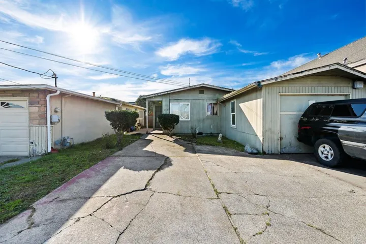 View of front of home featuring concrete driveway and a garage