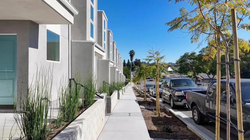 Modern new-construction townhomes with sidewalks and neighborhood context.