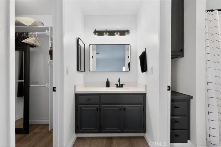 Private vanity  in  second bath adjacent  to roomy closet and and linen storage.