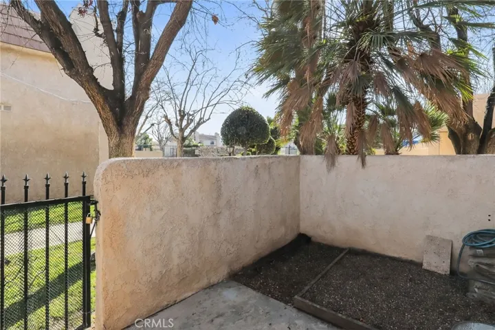 Rear patio with private gate that leads to the greenbelt and pool area. Planting area can be grass for your puppy, flowers or vegtables and herbs.