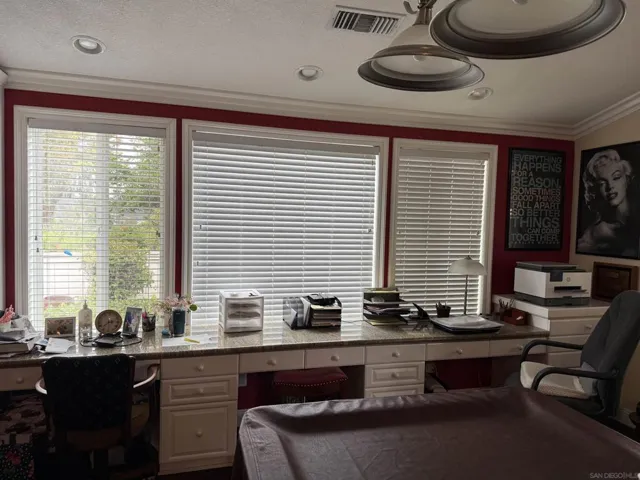 Family room with 3 built-in desks with filing drawers and drawers.  Granite counter tops.