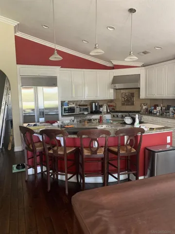Gourmet grand island kitchen with upgraded high end appliances.  This kitchen/family room required 3 slabs of granite.  This kitchen is any chefs delight with wide open walkways.