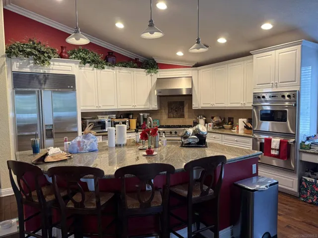 Beautiful cranberry red accent walls.  High end appliances.