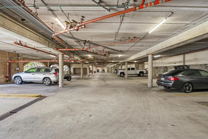 Gated parking garage with 2 dedicated spots:  14 and 18 + mini cabinet storage
