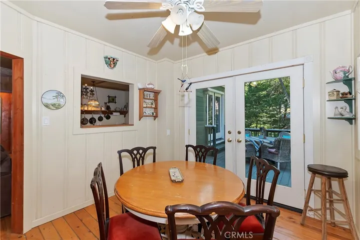 Charming dining space with original wood floors that opens seamlessly to a lovely patio, creating a light-filled setting for everyday meals or gatherings.