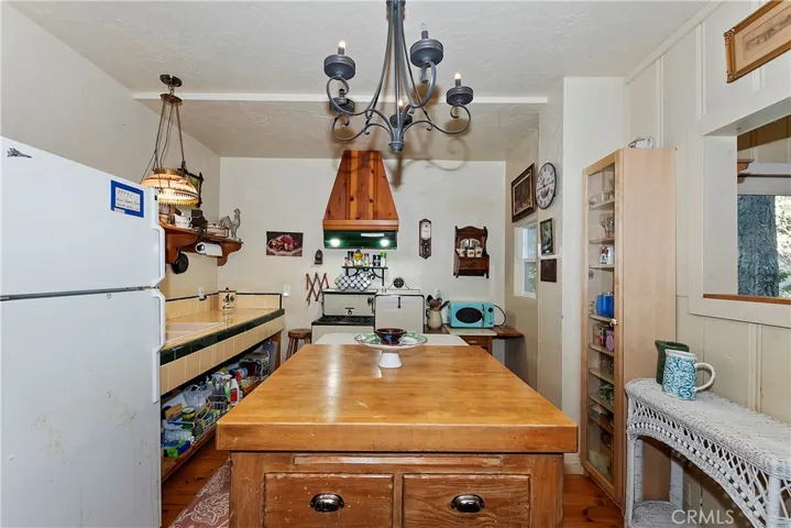 Character-rich kitchen showcasing a vintage stove and custom island that complement the home’s authentic mountain aesthetic.