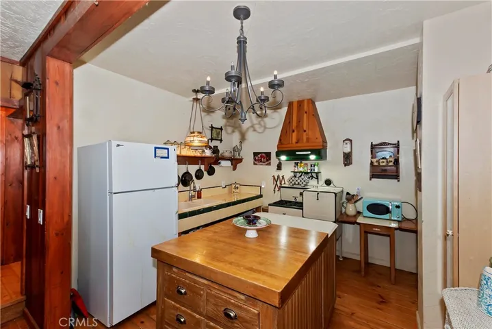 Charming kitchen featuring a vintage stove and functional island, blending classic cabin character with everyday usability.