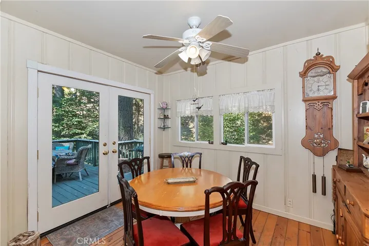 Dining area featuring original wood floors with direct access to a lovely patio—ideal for easy indoor-outdoor living and entertaining.