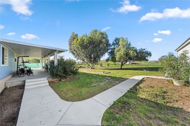Walk from the side of home to the backyard large covered and walk to the garage/workshop