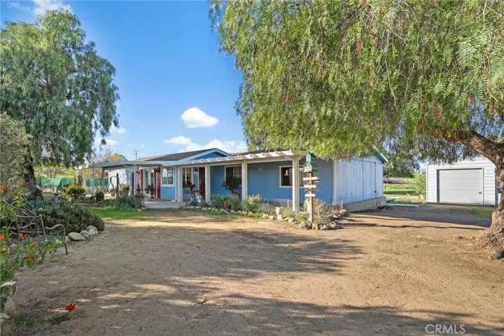 Front of home showing separate garage/workshop to the side of home