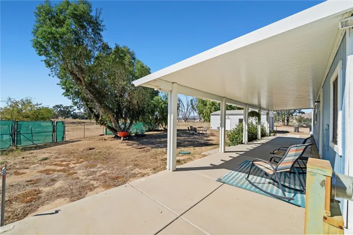 View from back patio during teh summer showing back gate on property