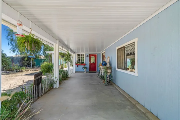 Covered front patio to entrance into home