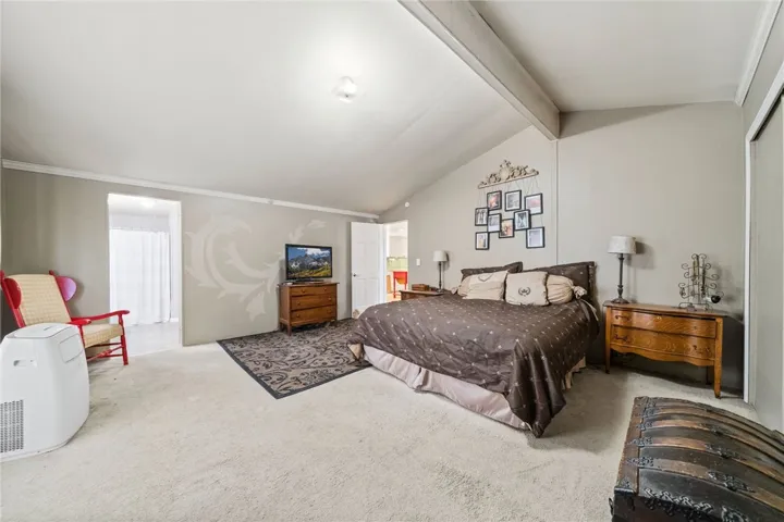 Primary bedroom has vaulted ceiling