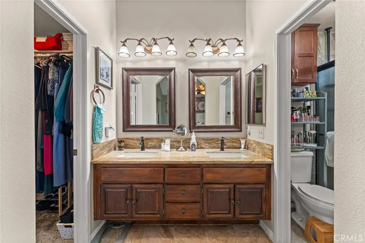 Primary Bathroom with Double Sinks, Granite Countertops, Upgraded Mirrors and Lighting