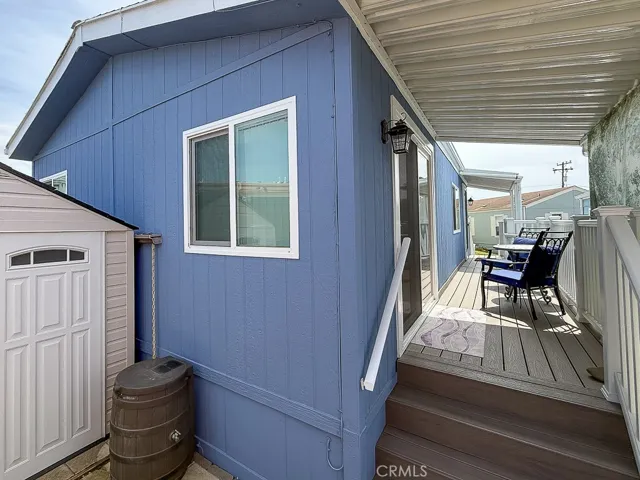 Shed with water catchment barrel