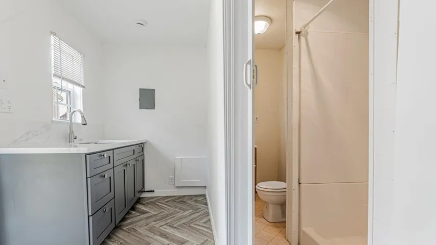 Full bathroom with vanity and toilet