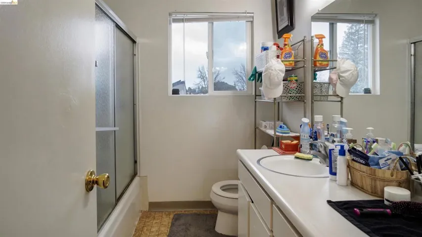 Full bathroom with vanity and shower / bath combination with glass door